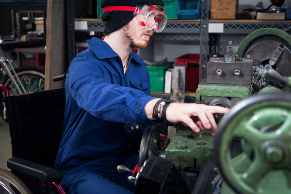 Apprentice using a wheelchair at work