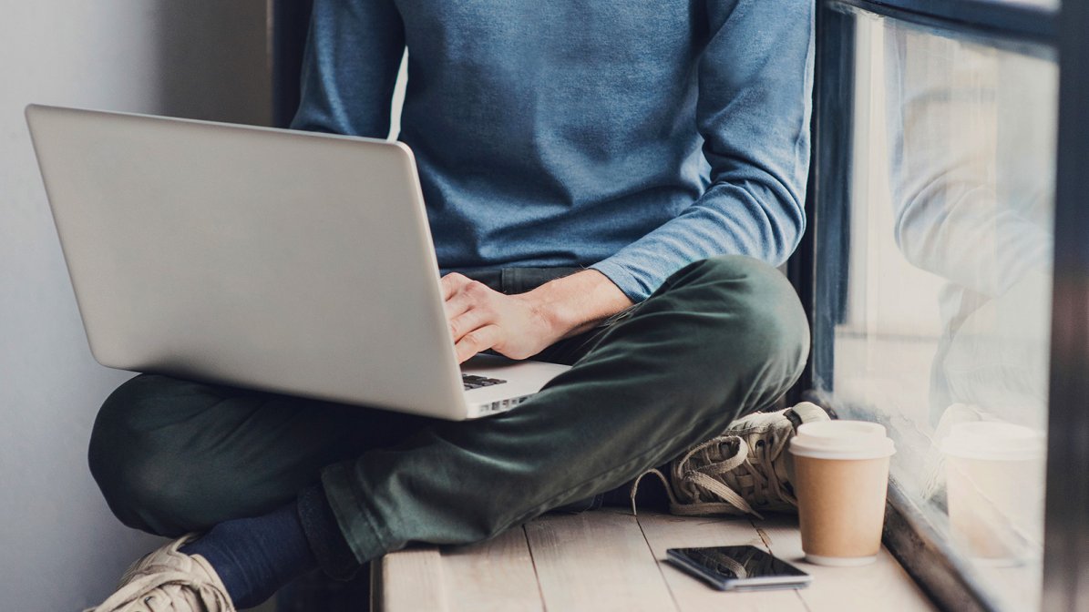 Student sat in the window using a laptop