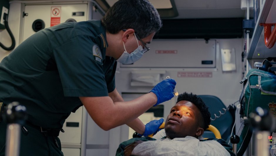 Paramedic treating patient in an ambulance