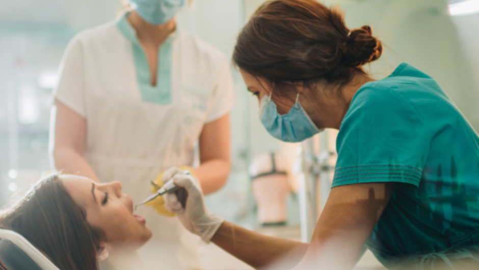 Dentist carrying out dental work on patient 