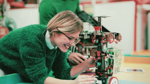 An apprentice works on an intricate machine