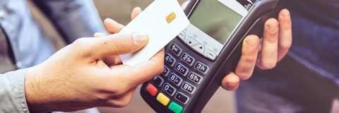 Student holding a credit card and mobile phone