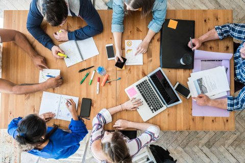 people conducing a meeting at a table